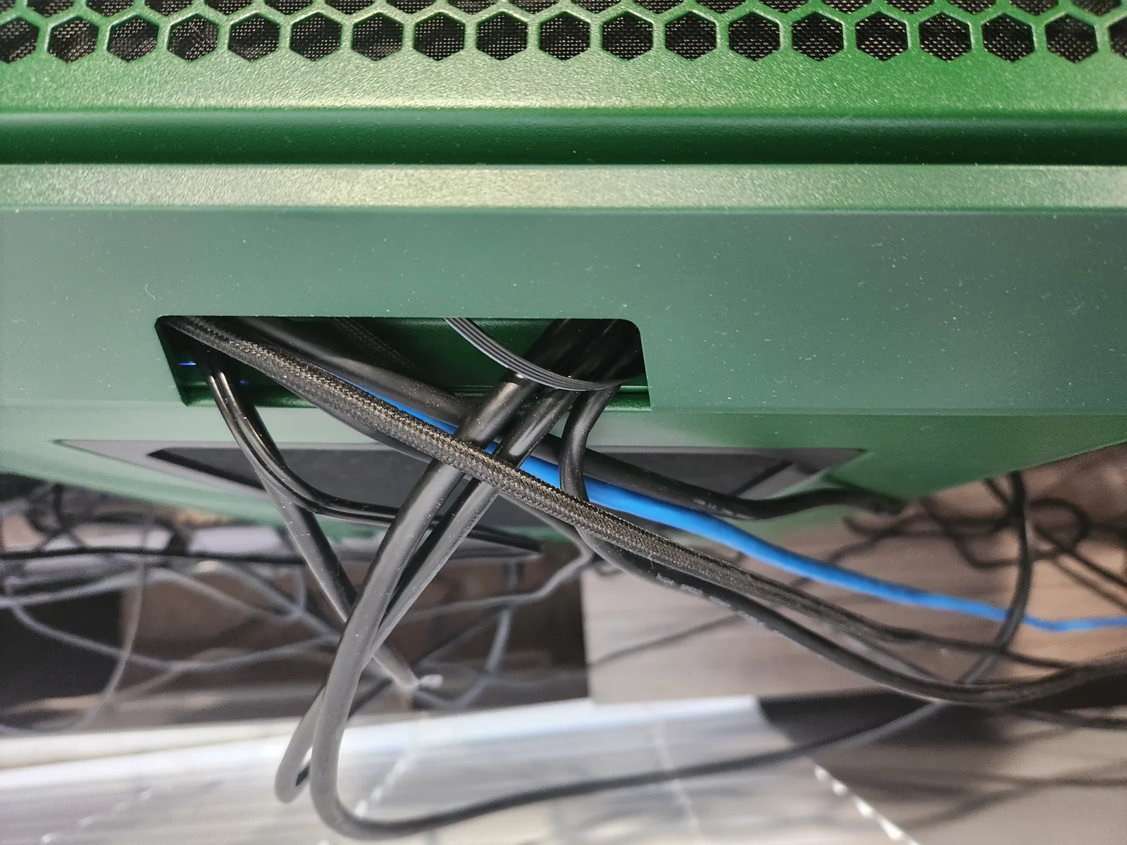 The cables all route out of the top of the back of the case
